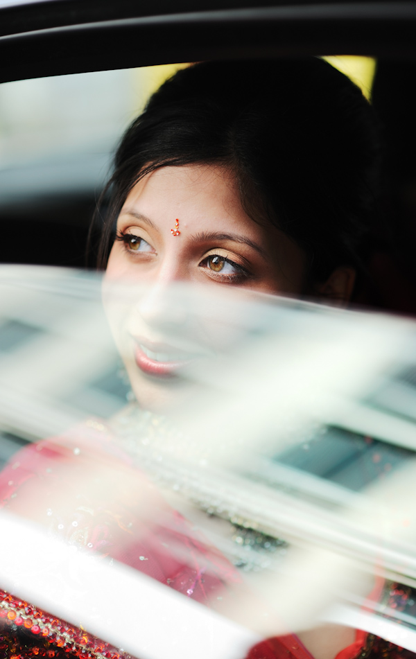 beautiful indian bride looking out of car window -photo by New York City based wedding photographer Ryan Brenizer